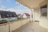 Überdachter Südbalkon mit Sonnenmarkise und praktischer Abstellnische